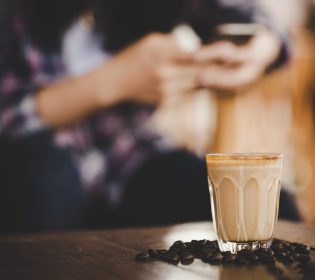 Cup of coffee latte on wood table in coffee shop cafe